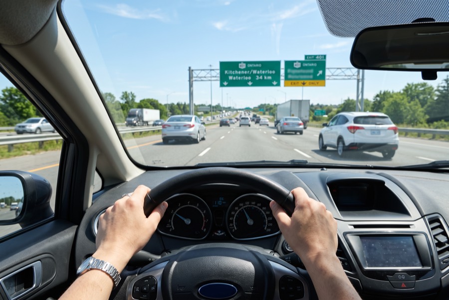 Driver's view over the wheel on a sunny multi-lane Ontario highway